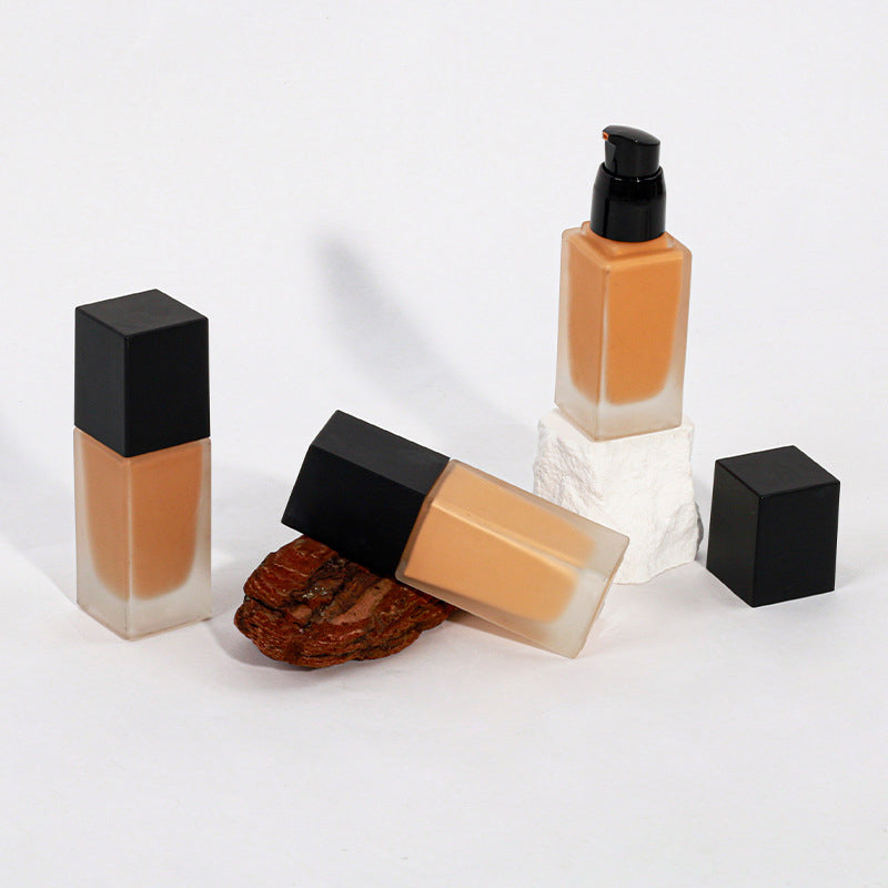 Dark brown concealing foundation with a sun-tanned, wheat-colored, and moist finish
