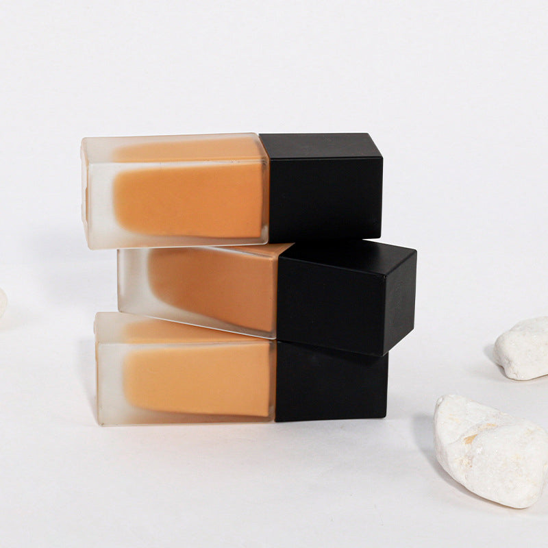 Dark brown concealing foundation with a sun-tanned, wheat-colored, and moist finish