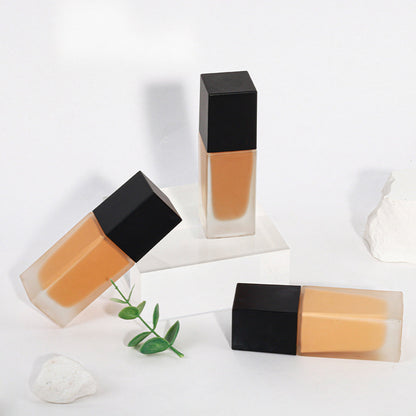 Dark brown concealing foundation with a sun-tanned, wheat-colored, and moist finish
